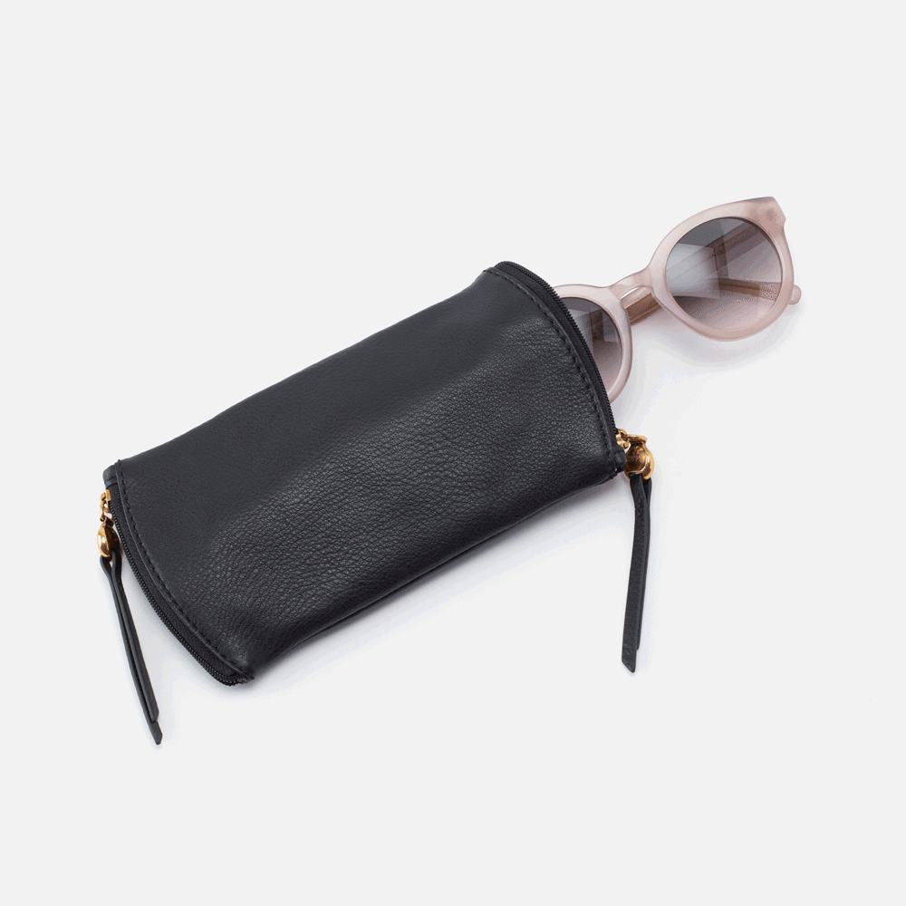 black spark glasses case with sunglasses partly in one side on a white background