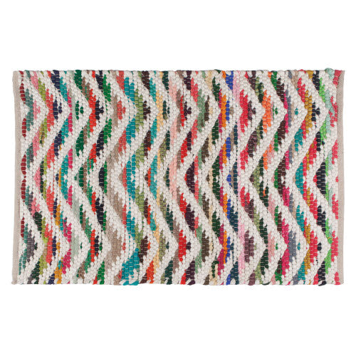 rug woven from colorful fabrics and white fabric to form a zig-zag design.