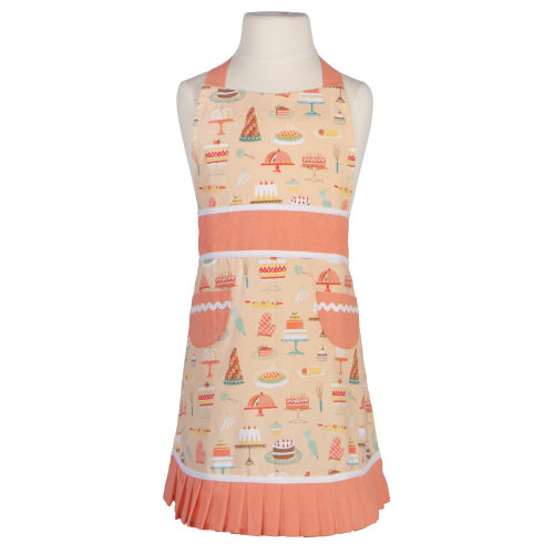 pink child's apron with cake graphics on mannequin.