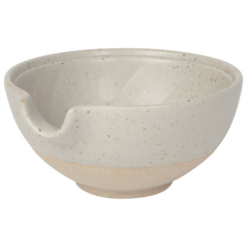 small off-white bowl with exposed terracotta base and pouring spout.