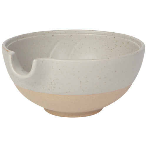 medium off-white bowl with exposed terracotta base and pouring spout.