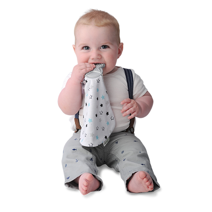 a little boy chewing on the twinkle twinkle munch it blanket against a white background