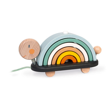 side view of wooden turtle with rainbow shaped wooden pieces cocooned together to form the back of the turtle on a pully string