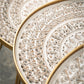 close up view of the tops of the gold and white accent table