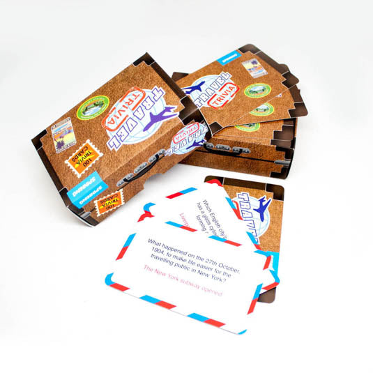 the travel trivia package displayed open next to the trivia cards on a white background