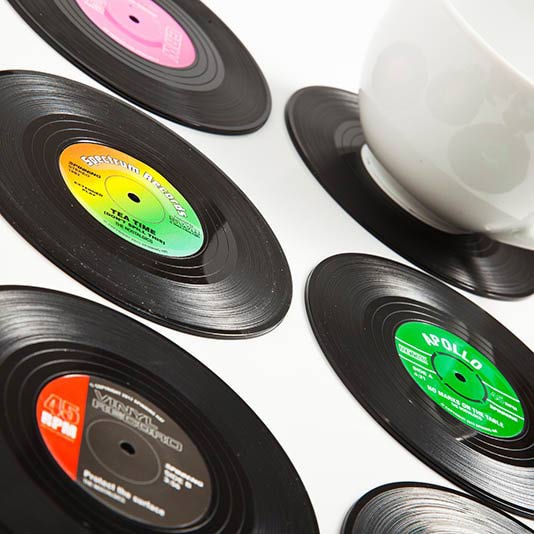 six vinyl coasters displayed on a white background with a coffee cup