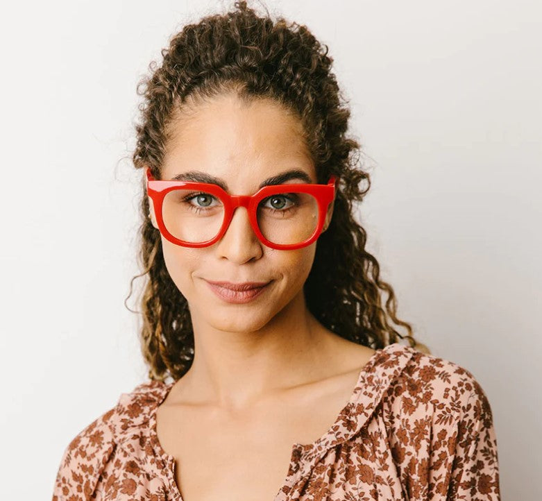 front view of a woman modeling the red harlow glasses against a cream background