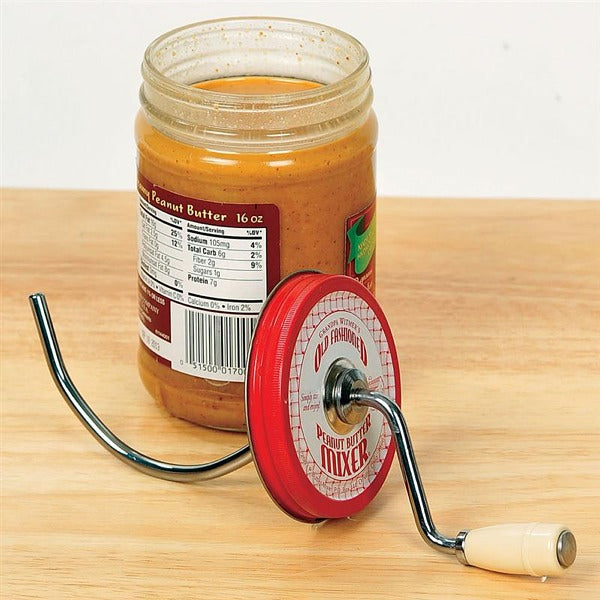 the natural peanut butter mixer displayed next to a open jar of peanut butter on a wooden surface