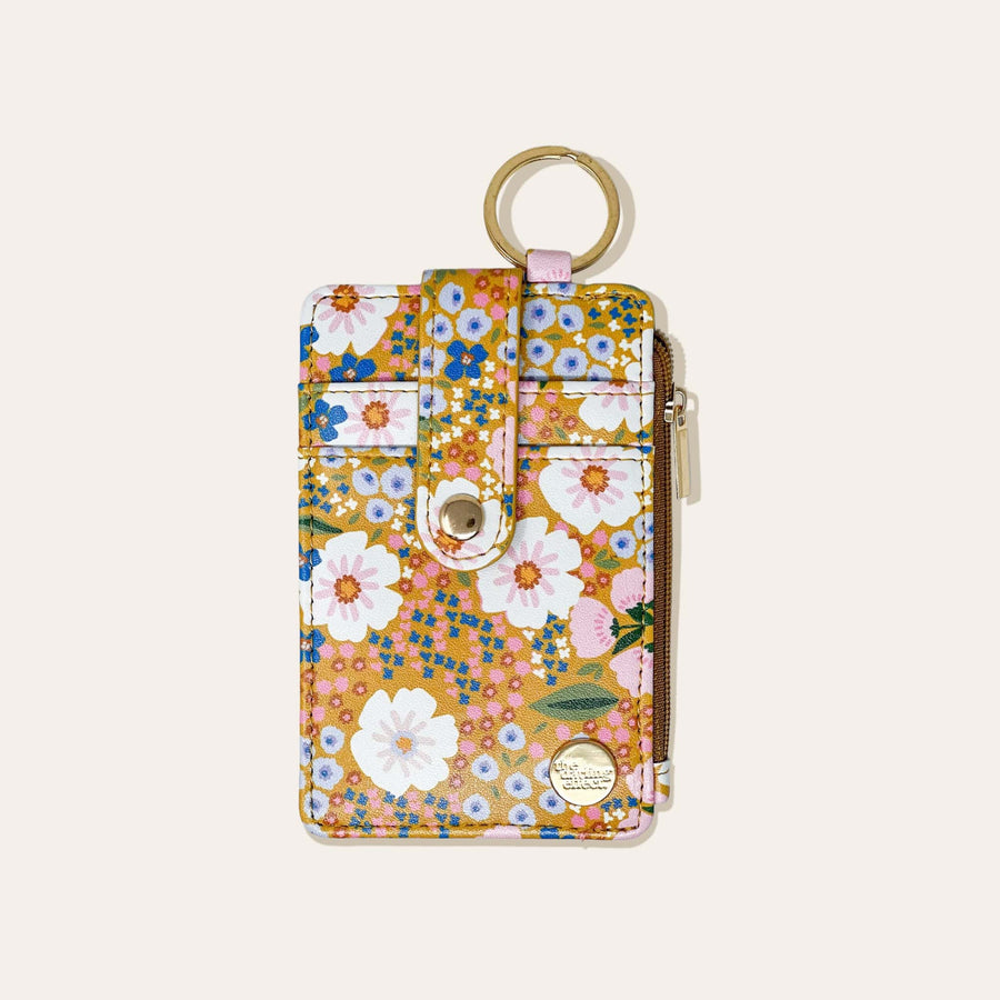 mustard wallet with floral design on a white background.