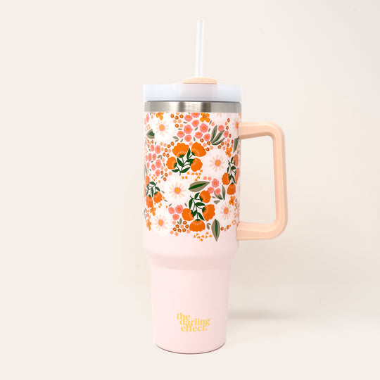 sweet meadow take me everywhere tumbler is peach with pink, orange, and white flowers all over
