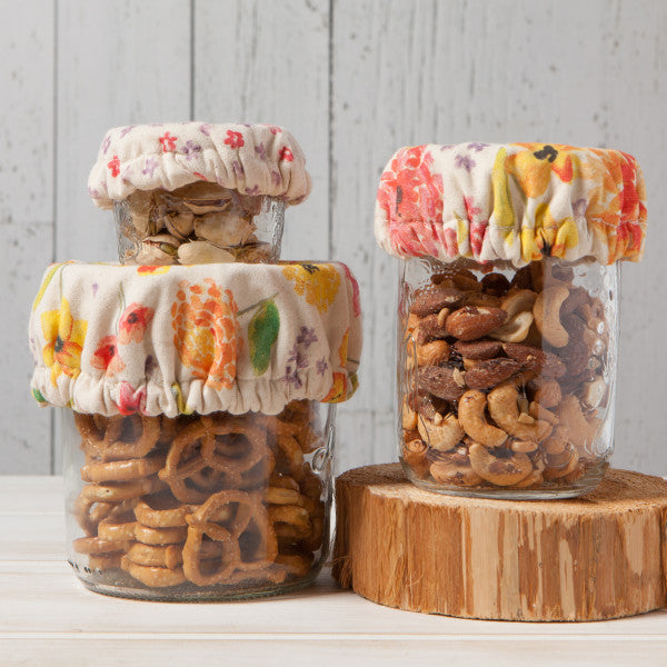 side view of covers on jars filled with snacks.
