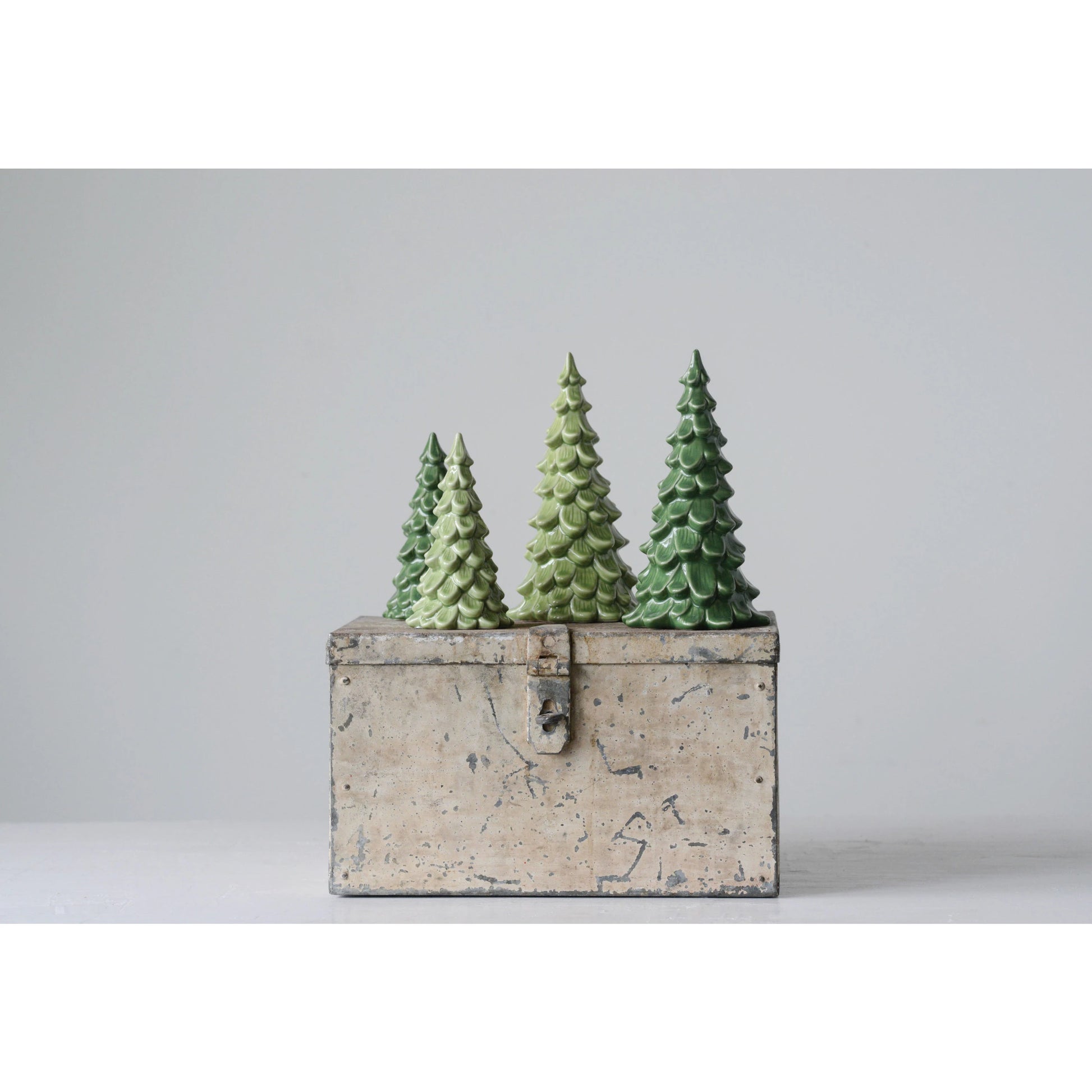 green ceramic trees on metal box.