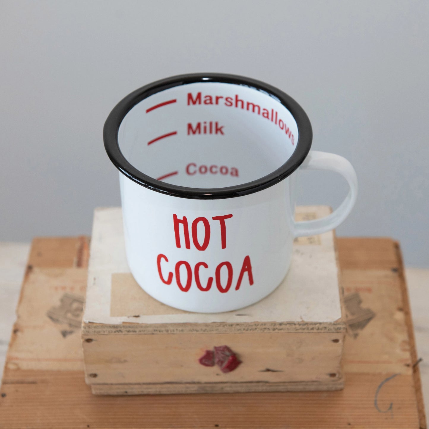 top view of mug showing interior writing: marshmallow, milk, cocoa.