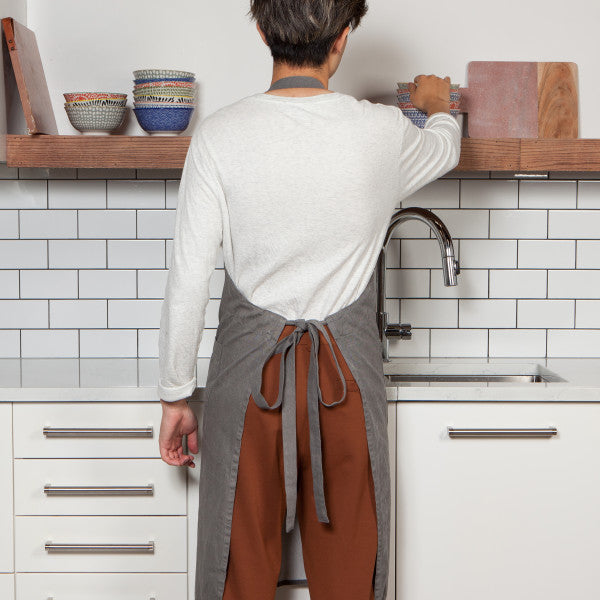 back view of person wearing apron.