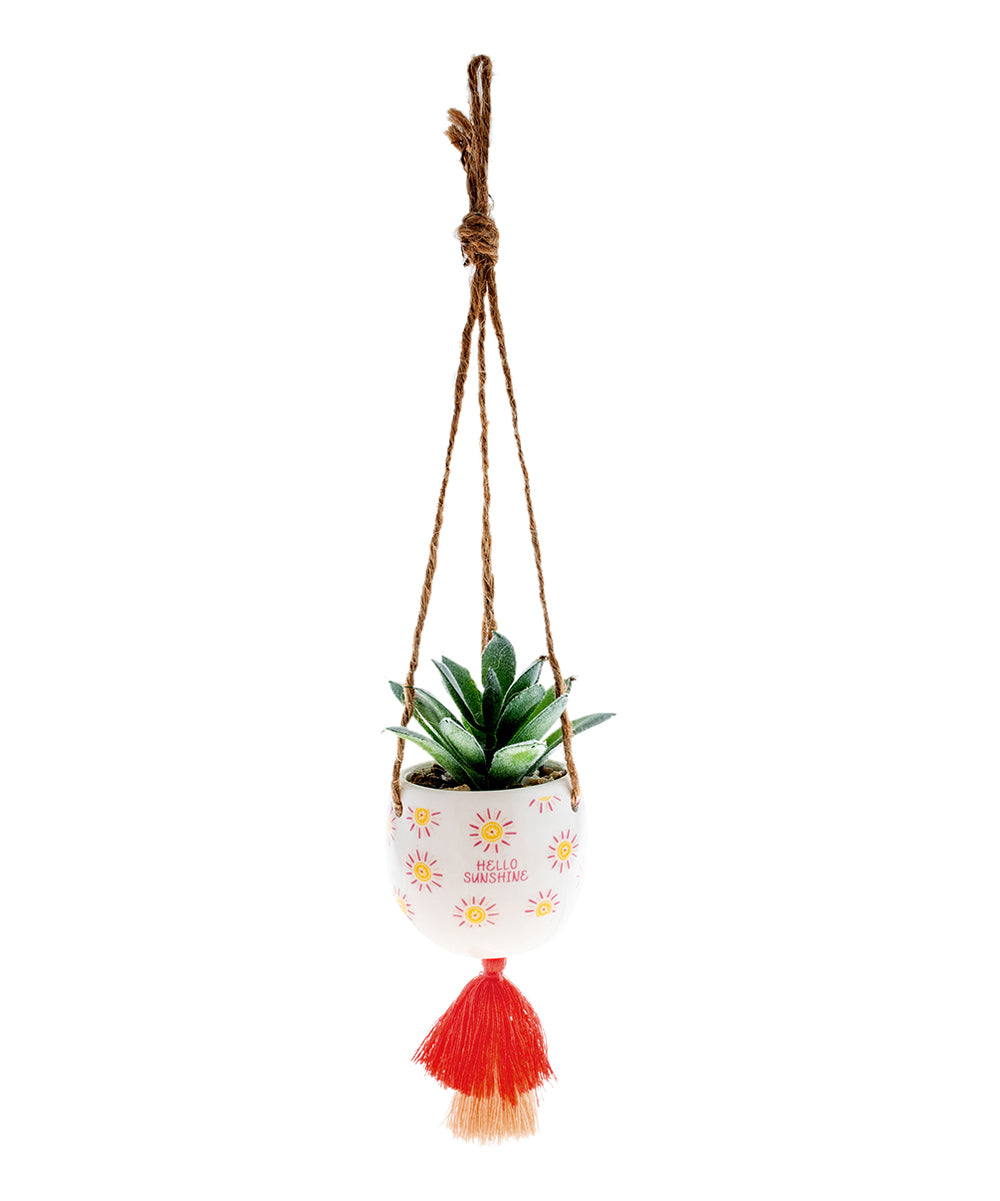 small ceramic pot with a succulent in it hanging form jute twine with a tassel on the bottom, sun graphics, and "hello sunshine" printed on it.